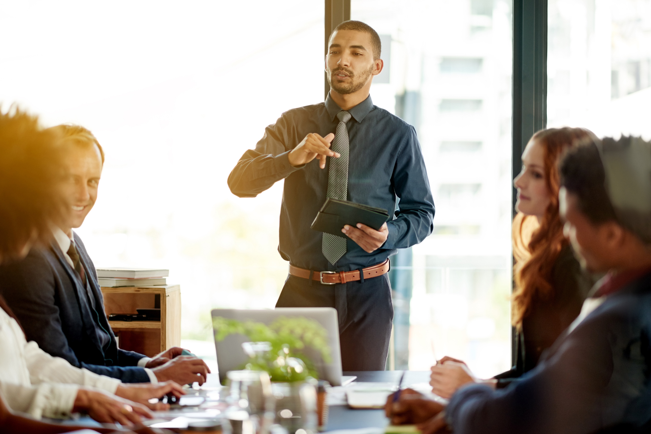 Group of business people in a meeting together conversing