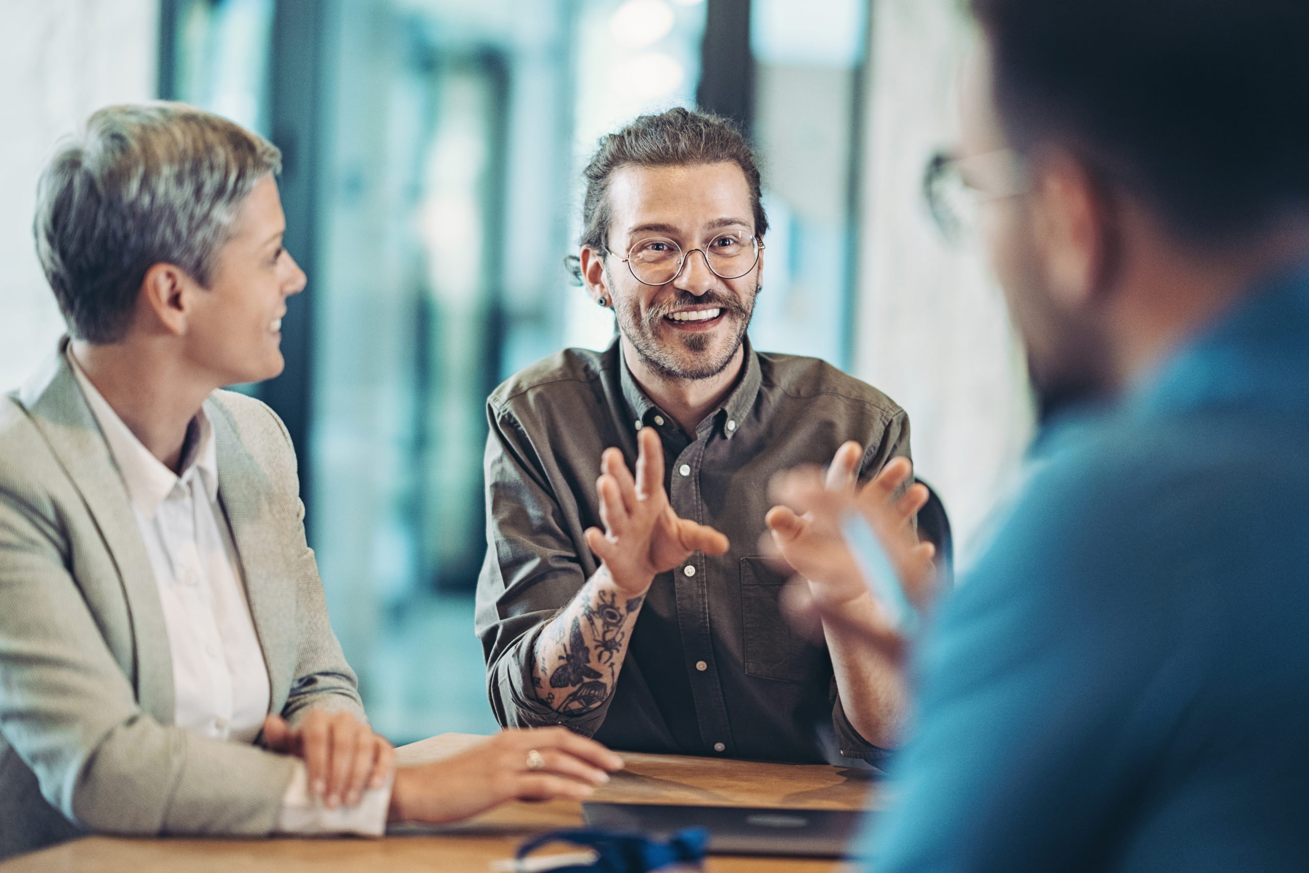 man excitedly sharing information with his team