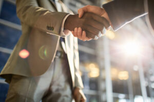 business people shaking hands after making a deal