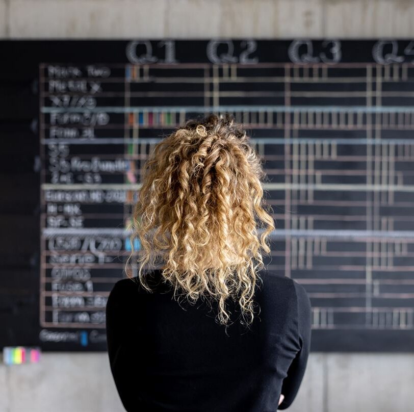 Woman looking at data on a board