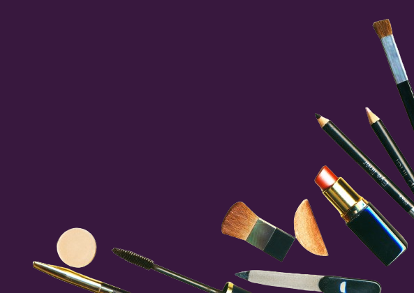 makeup and brushes laying on a purple background