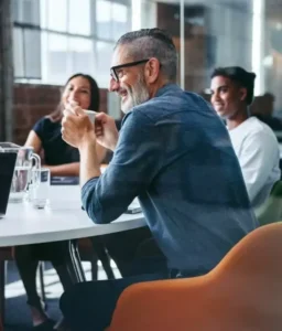 man in business meeting drinking from mug