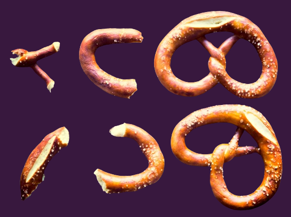 whole pretzels and pieces of broken pretzels on a purple background